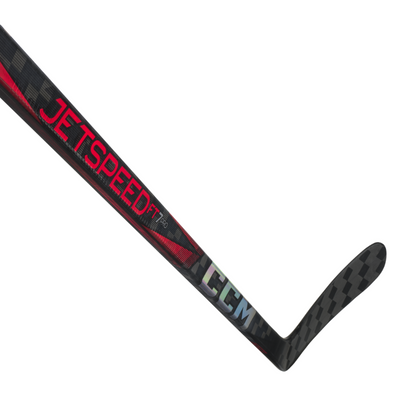 CCM Hockey Sticks CCM JetSpeed FT7 Pro (2024) Senior Black/Red side diagonal close-up of shaft with blade pointing to the upper-right