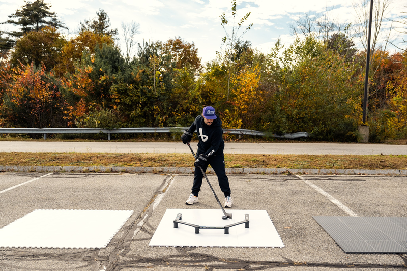 Bauer Dryland Training Tiles 10 Pack person outside stickhandling a puck on training tiles with the Bauer Reactor Stick Handling Trainer