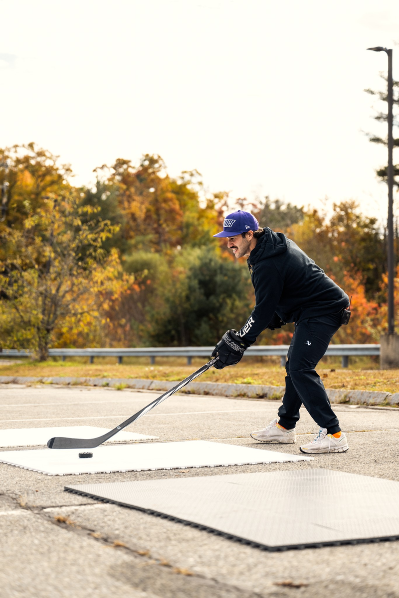 Bauer Dryland Training Tiles 10 Pack person outside stickhandling a puck on training tiles